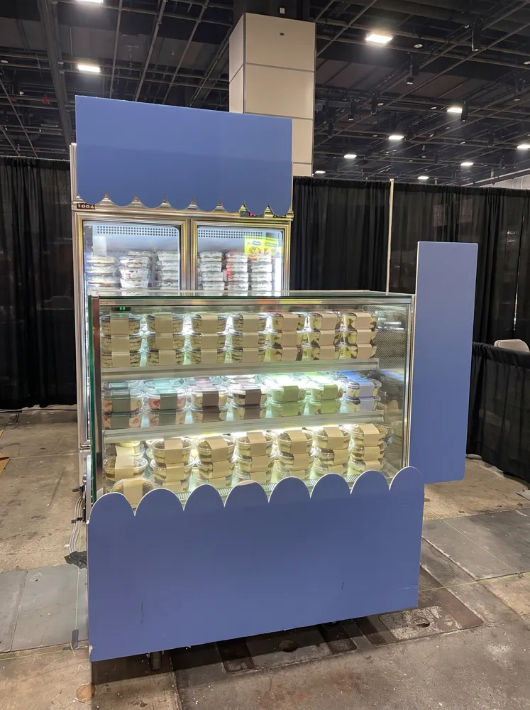 AANRS cake chiller rental Singapore, glass display of boxed desserts dressed with scalloped panels, with a two-door chiller behind