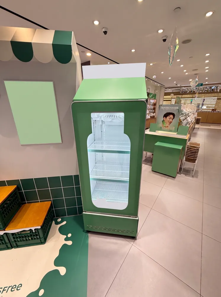 AANRS display fridge rental Singapore, chiller wrapped as a tall green milk carton at a department store pop-up display