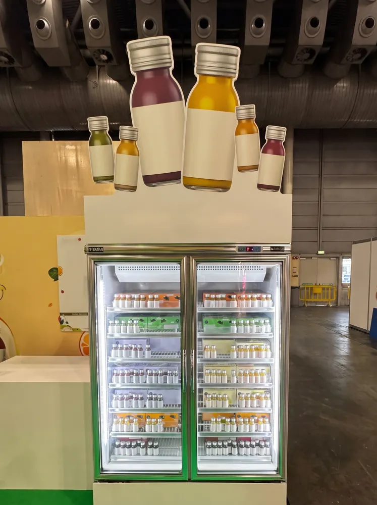 AANRS drink chiller rental Singapore, two-door chiller fully stocked with small bottled drinks under a bottle-shaped display header