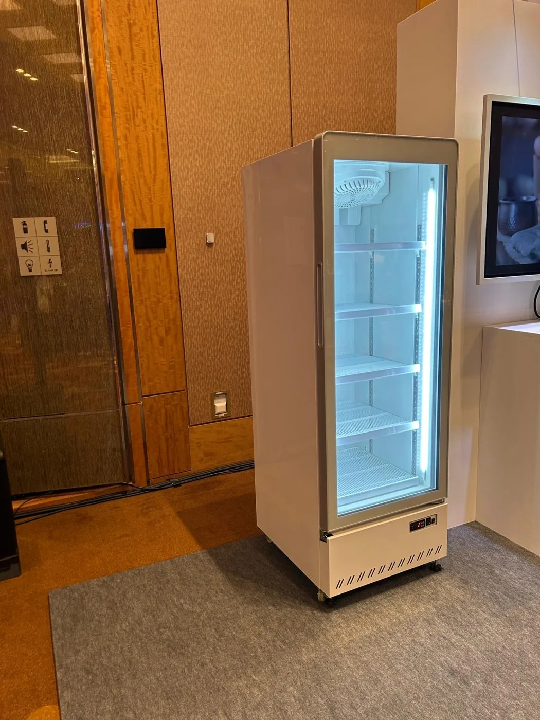 AANRS drink chiller rental Singapore, upright glass-door chiller standing empty in the corner of a hotel function space