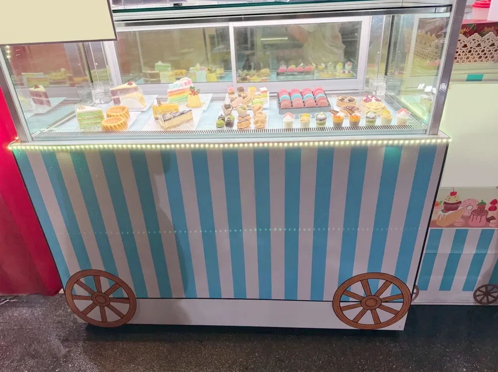 Candy cart display case with desserts at a carnival party